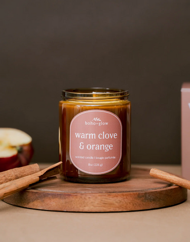 A warm clove and orange scented candle by